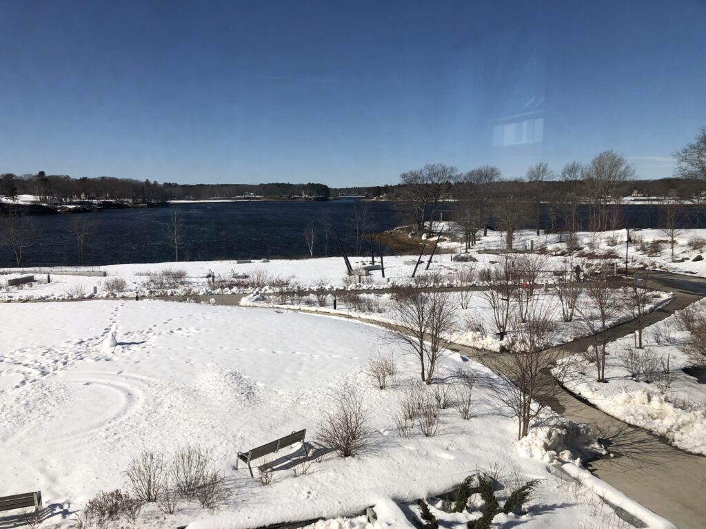 View from high window of water, snow, campus